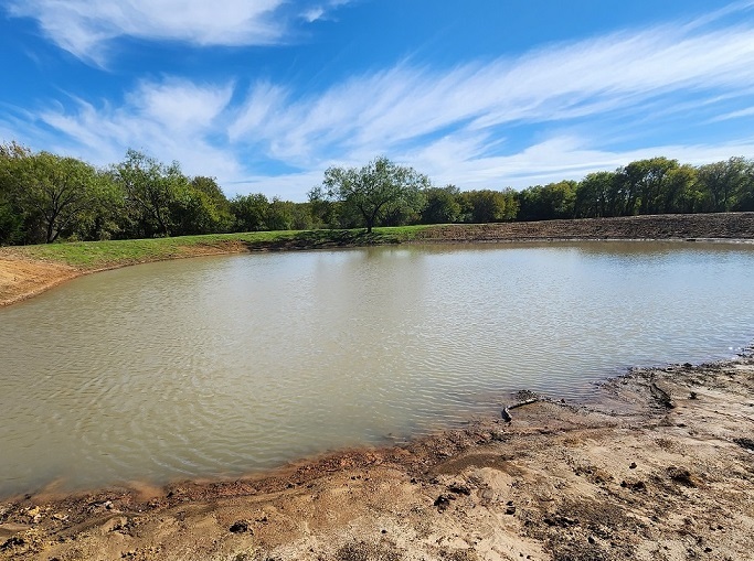 filled pond blue sky trim
